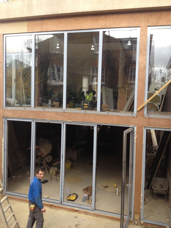 Aluminium bi-fold doors with two-storey glazing in Hampton